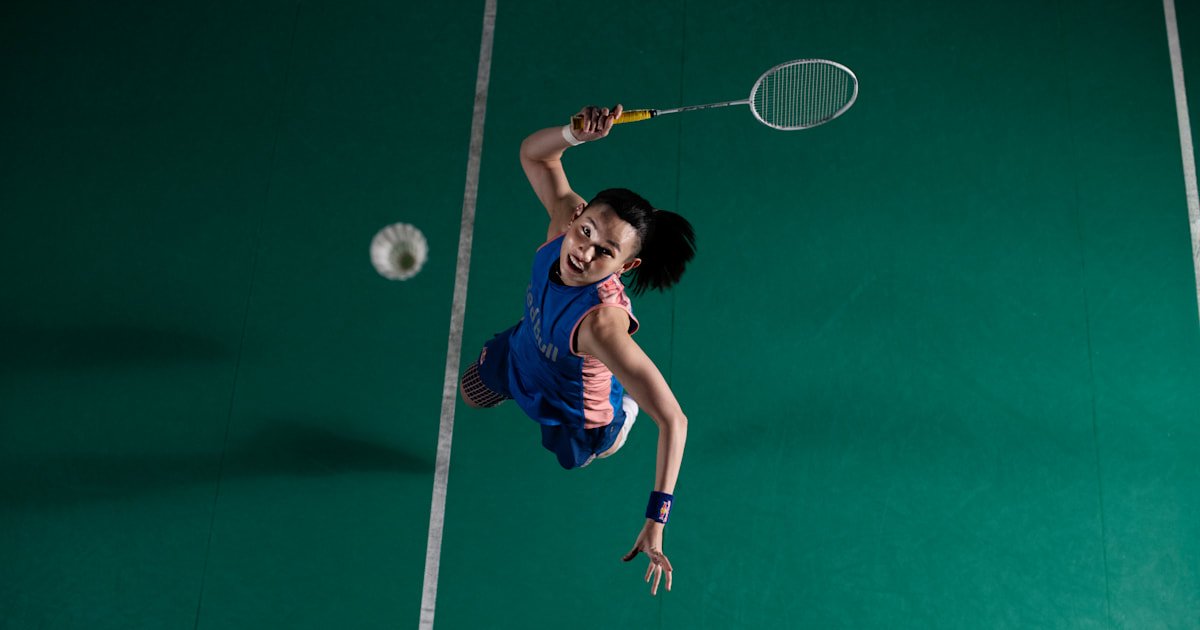 Badminton rackets and shuttlecocks arranged on a court